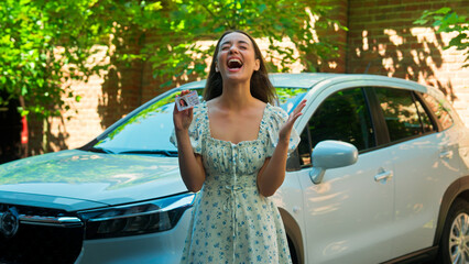 Happy excited amazed Caucasian woman female girl student client buyer buy new car automobile...