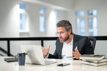 Modern office. Angry caucasian business man in business suit using laptop, working remotely, e-commerce online at office. Finance auditor. Ceo manager employee having business idea. Business startup.