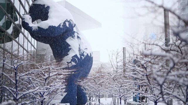 The Big Blue Bear and the Colorado Convention Center during a snowstorm.