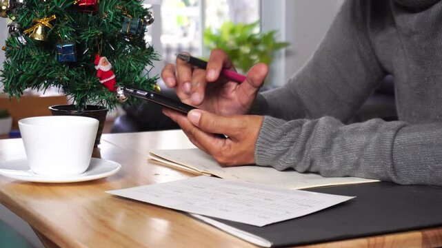 Planner or organizer writing daily appointment in Calendar book and using smartphone. Asian woman hand plan timetable meeting agenda and note schedule business in diary. Planner concept.