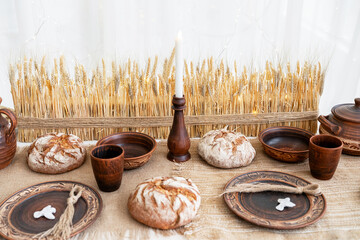 Festive winter table setting with baked bread and rustic decor for Christmas