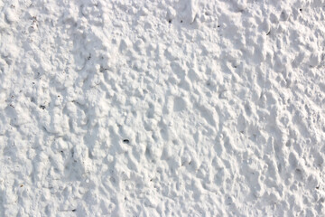 Texture of white concrete wall with cracks and scratches which can be used as a background