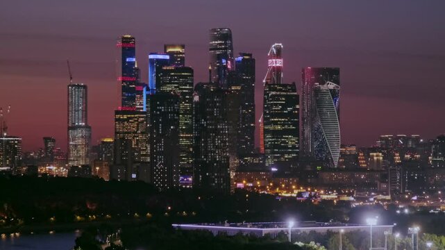 Moscow, Russia - Aug 16 2024: A captivating video showcasing the illuminated skyscrapers of Moscow City at night, reflecting the vibrant urban landscape