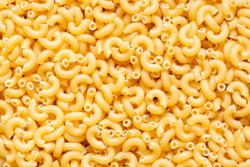 Macaroni dried pasta background backdrop. Italian food ingredients concept.