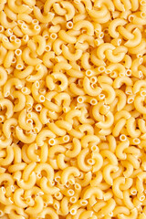 Macaroni dried pasta background backdrop. Italian food ingredients concept.