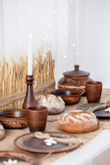 Rustic table set with handmade pottery and baked bread for winter