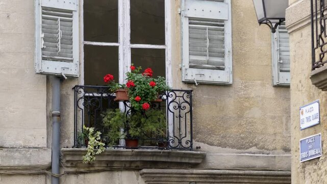 Charming windows with blue shutters and blooming flowers in Place des Trois Ormeaux, Aix-en-Provence, France