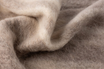 Alpaca wool mix soft warm scarf, pattern background. Trendy cream beige color wool texture