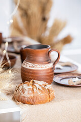 Cozy winter still life with bread and pottery for the holidays