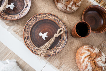 Festive table with handcrafted plates and rustic bread for holidays