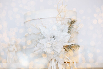 Elegant white gift box adorned with winter decorations for Christmas celebration