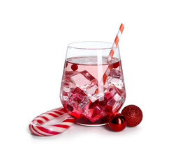 Tasty Christmas cocktail in glass and red baubles isolated on white