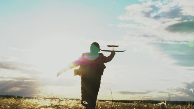 american child boy runs through park with toy plane his hand sunset sky, childhood dream son, child run wants become astronaut pilot, child wants become astronaut, boy, flight into future, child