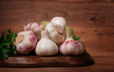 Fresh young garlic, white and purple color, on a wooden table, no people,