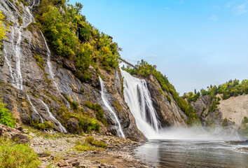 Obraz premium A view along the shoreline at the bottom of the Montmorency falls near Quebec City, Canada in the fall