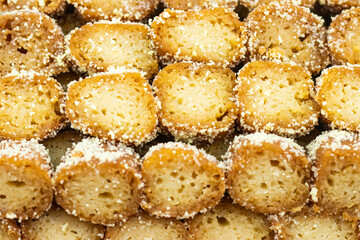 Mouchak Sandesh topped with coconut coating texture closeup side view of Indian, pakistani and bangladeshi sweet dessert food