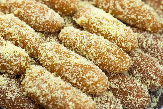 Lal Langcha, Lencha, Lengcha or Lemcha coating with coconut texture closeup side view of Indian, pakistani and bangladeshi sweet dessert food
