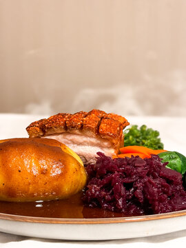Norwegian Christmas Dinner - Ribbe Pork Plate with potatoes, Christmas sausage, red cabbage, brussel sprouts and brown sauce