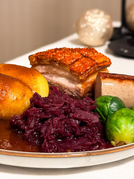 Norwegian Christmas Dinner - Ribbe Pork Plate with potatoes, Christmas sausage, red cabbage, brussel sprouts and brown sauce