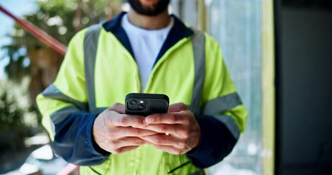 Man, engineer and hands typing with phone for planning construction project, infrastructure and site development. Architect, mobile and builder outdoor for communication, message and check schedule