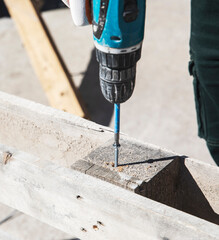 a man in a protective helmet with an electric saw to do the work