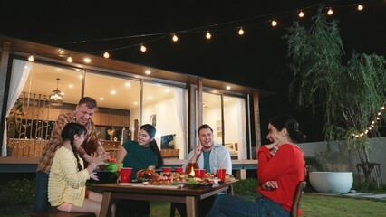 Family together celebrate anniversary in garden. Senior give gift to granddaughter. Outdoor camping activity to relax with relatives, spend time with multigeneration cross generation gap. Divergence.