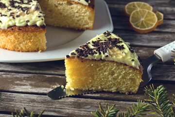 Close-Up of Lemon Cake with Chocolate Crumble on a Wooden Table in a Festive Setting