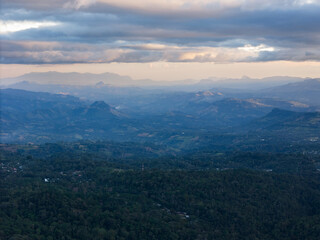 Expansive mountain landscape under dramatic sky at dusk