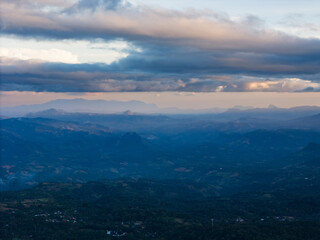 Stunning panoramic view of mountains under dramatic clouds during twilight hours