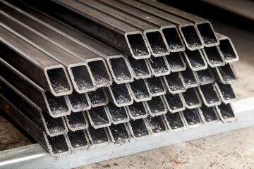 A cross-section of metal pipes lying in a stack