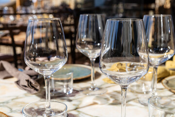 empty wine glasses in the sun on a restaurant table