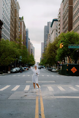 Fototapeta premium A confident woman is strolling down the street in stylish robe