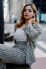A fashionable confident woman in a stylish outfit in a modern city setting