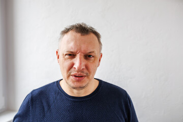distorted face of sad and grieved very upset person, dissatisfied with his hard fate