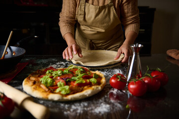 Chef preparing homemade pizza dough in a rustic kitchen setting