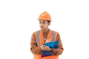 Young Indonesian male construction worker in full safety clothing is filling out a report on a clipboard, construction and industry concept, isolated on white background.