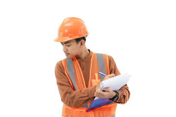 Young Indonesian male construction worker in full safety gear is seen focusing on filling out a report on a clipboard, construction and industry work concept, isolated on white background.