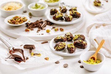 Preparing exquisite dessert, dates filled with pistachio mousse, alternative to popular Dubai...
