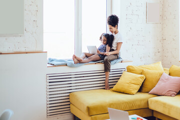 Mother and daughter spending time with tablet