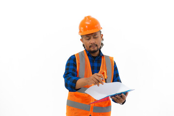 Indonesian male construction worker in full safety clothing filling out report on clipboard, construction and industry concept, isolated on white background.