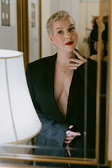 Stylish woman in blazer exudes elegance and selfassurance with her bold look