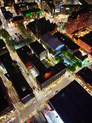 Aerial Night View of Illuminated Central Manchester City and Downtown Buildings, England United Kingdom. High Angle Footage Was Captured with Drone's Camera on May 4th, 2024 During Midnight.