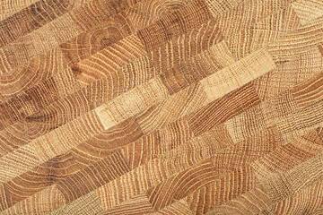 Fototapeta premium Oak wooden board as background, top view. Cross section of tree trunk. Natural durable end grain hard wood cutting board.