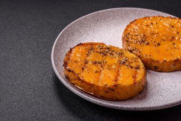Pumpkin cut into slices and grilled with rosemary and spices