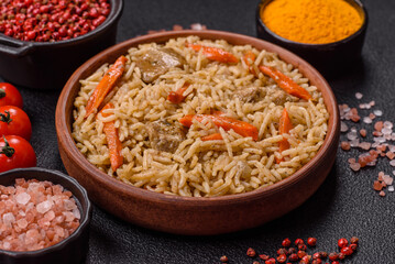 Delicious fresh pilaf with rice, carrots, meat, onions, spices and berries