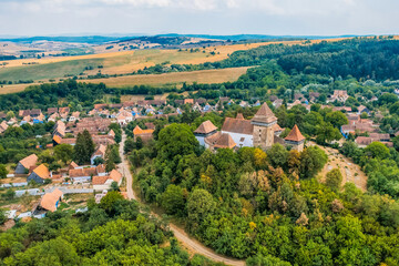 Viscri, Romania. Blue old painted traditional house from village, Transylvania. The Viscri fortified church