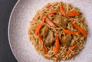 Delicious fresh pilaf with rice, carrots, meat, onions, spices and berries