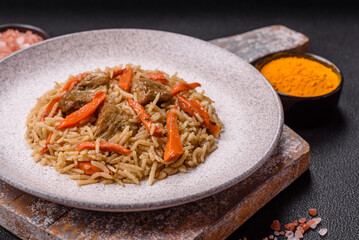 Delicious fresh pilaf with rice, carrots, meat, onions, spices and berries