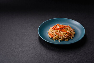 Delicious fresh pilaf with rice, carrots, meat, onions, spices and berries