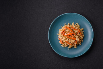 Delicious fresh pilaf with rice, carrots, meat, onions, spices and berries